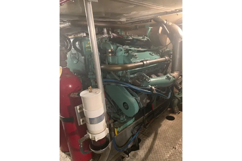 Slide: The Image of Engine room of a 1968 Burger Motor Yacht, showcasing mechanical components and piping. - 25