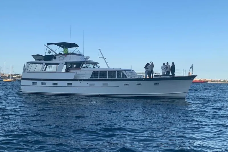 Slide: The Image of 1968 Burger Flush Deck Motor Yacht on water with people onboard. - 3