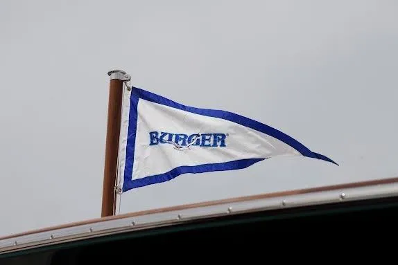 Slide: The Image of Flag on 1968 Burger Motor Yacht, featuring blue and white design. - 30