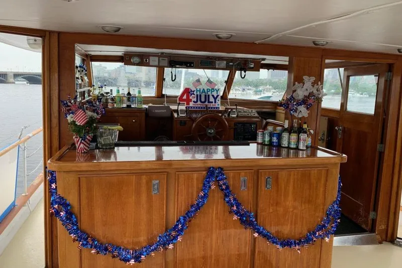 Slide: The Image of 1968 Burger Motor Yacht interior decorated for Fourth of July celebration with bar and festive decor. - 6