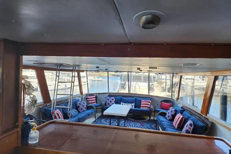Slide: The Image of Luxurious 1968 Burger Motor Yacht interior with elegant seating and marina view. - 9