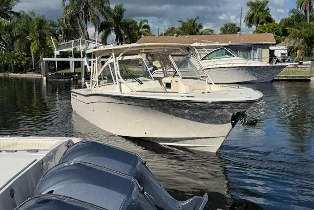 Slide: The Image of 2021 Grady-White Freedom 307 boat docked in a scenic marina setting. - 11