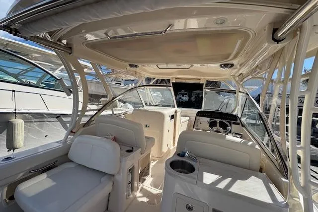 Slide: The Image of Interior of 2021 Grady-White Freedom 307 boat, featuring spacious seating and modern controls. - 16