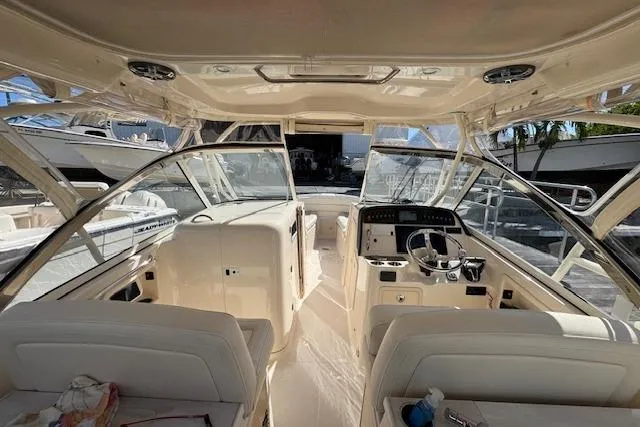 Slide: The Image of 2021 Grady-White Freedom 307 boat interior with helm and seating area. - 18