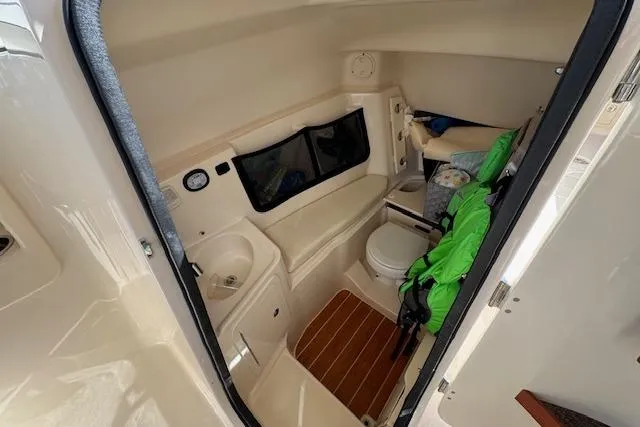 Slide: The Image of 2021 Grady-White Freedom 307 boat interior with compact bathroom amenities. - 23