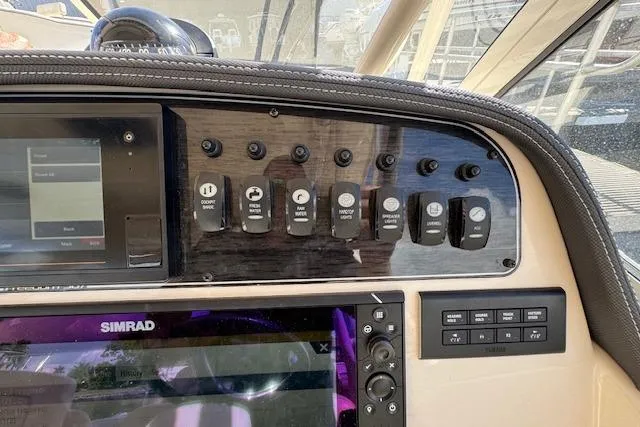 Slide: The Image of Dashboard of 2021 Grady-White Freedom 307 boat with control switches and Simrad display. - 32