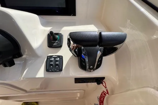 Slide: The Image of Control panel of 2021 Grady-White Freedom 307 boat with throttle and switches. - 34