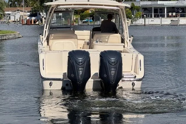 Slide: The Image of 2021 Grady-White Freedom 307 boat with dual outboard engines on a calm waterway. - 6