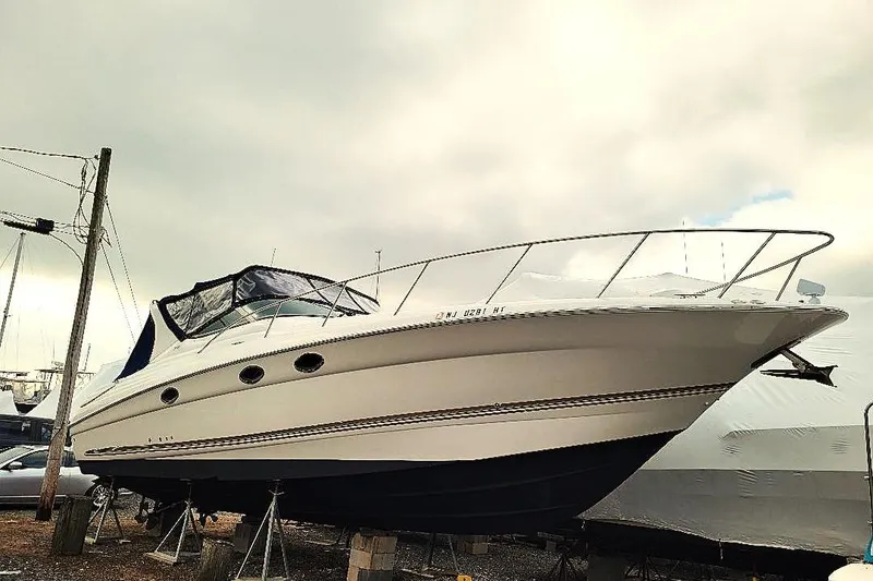 Slide: The Image of 2004 Wellcraft 3700 Martinique boat on dry dock under cloudy sky. - 35