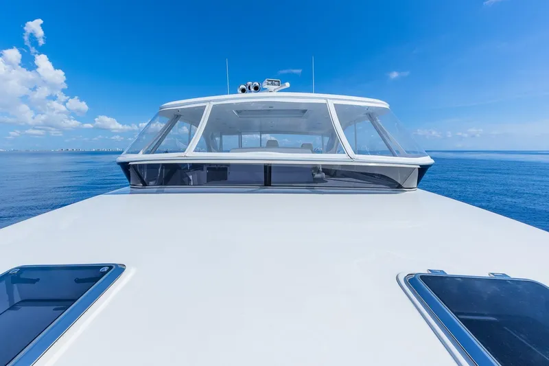 Slide: The Image of 2019 Regency P65 yacht cruising on open sea under clear blue sky. - 12