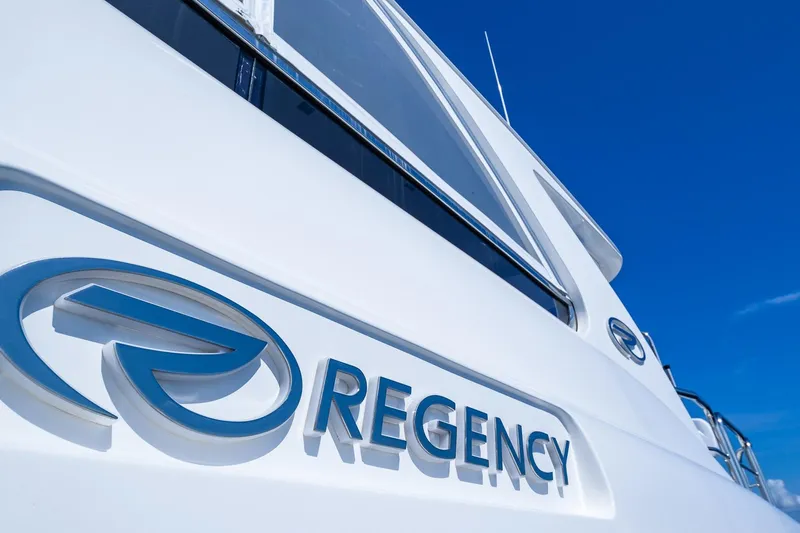 Slide: The Image of 2019 Regency P65 yacht with logo against clear blue sky. - 13