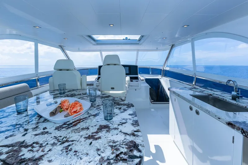 Slide: The Image of Luxurious 2019 Regency P65 yacht interior with marble countertops and ocean view. - 14