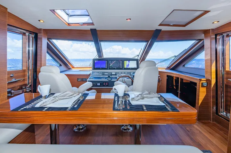 Slide: The Image of Luxurious 2019 Regency P65 yacht interior with elegant dining setup and panoramic ocean views. - 32