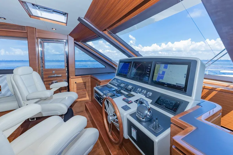Slide: The Image of Luxurious 2019 Regency P65 yacht helm with advanced navigation systems and plush seating. - 36