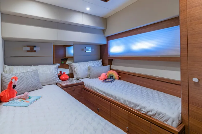 Slide: The Image of Luxurious 2019 Regency P65 yacht bedroom with twin beds and plush decor. - 45