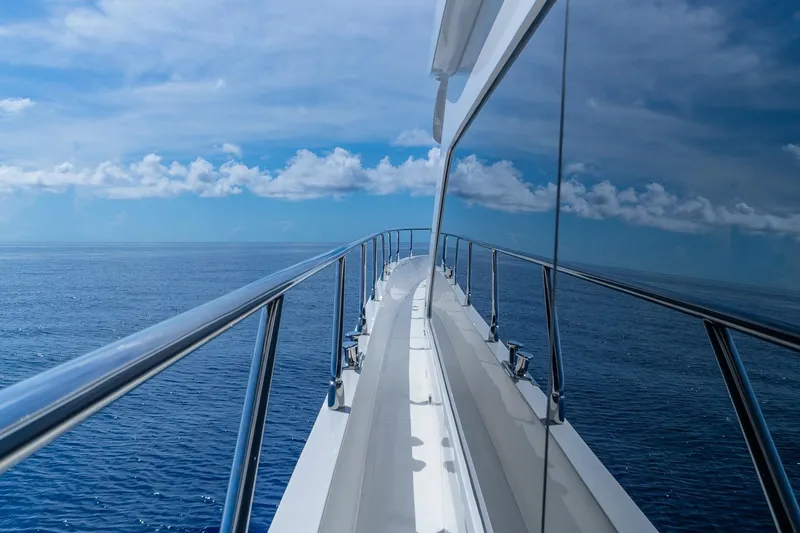 Slide: The Image of Luxurious 2019 Regency P65 yacht cruising on open ocean under clear blue skies. - 5