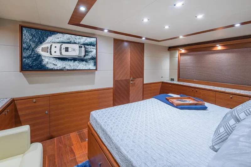 Slide: The Image of Luxurious Regency P65 yacht bedroom interior with wood accents and nautical artwork, 2019 model. - 51