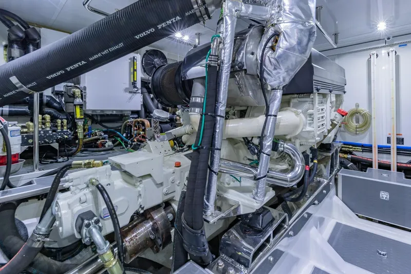 Slide: The Image of Engine room of a 2019 Regency P65 yacht, featuring Volvo Penta marine components. - 56
