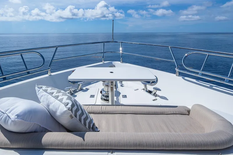 Slide: The Image of Luxurious 2019 Regency P65 yacht deck with cushions, table, and ocean view. - 9