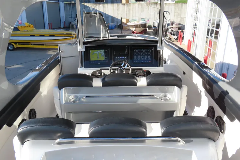 Slide: The Image of 2017 Mystic M4200 boat cockpit with advanced navigation system and luxurious seating. - 12