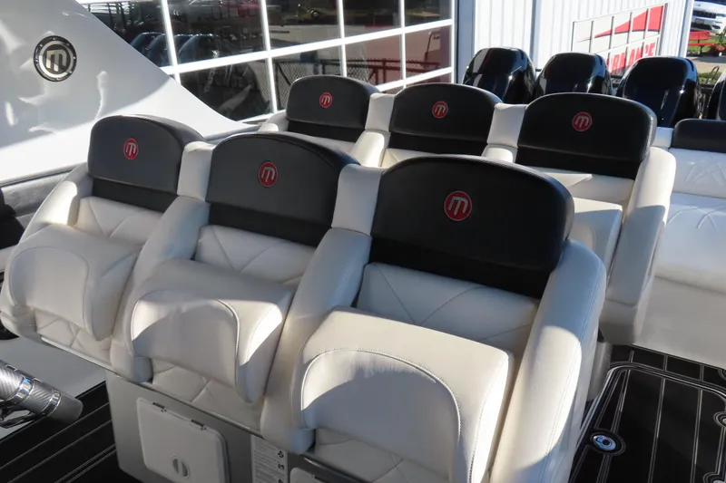 Slide: The Image of Luxury seating on a 2017 Mystic M4200 boat, featuring sleek white and black design. - 13
