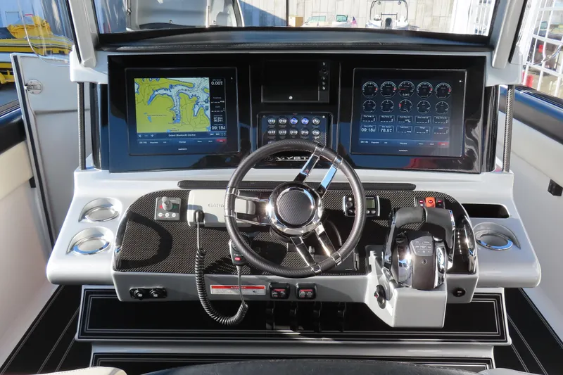 Slide: The Image of Control panel of a 2017 Mystic M4200 boat with advanced navigation displays. - 15