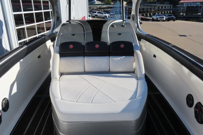 Slide: The Image of Luxurious seating on a 2017 Mystic M4200 boat, featuring sleek white and black upholstery. - 17