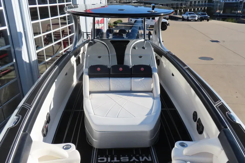 Slide: The Image of 2017 Mystic M4200 boat interior with white seating and sleek design. - 18