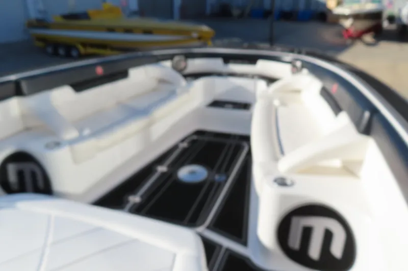 Slide: The Image of Blurry interior of a 2017 Mystic M4200 boat with white seating. - 19