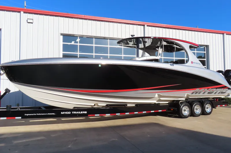 Slide: The Image of 2017 Mystic M4200 boat on Myco trailer, parked outside a building. - 2