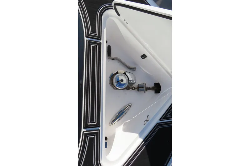 Slide: The Image of Open anchor compartment on 2017 Mystic M4200 boat, featuring anchor chain and winch. - 22