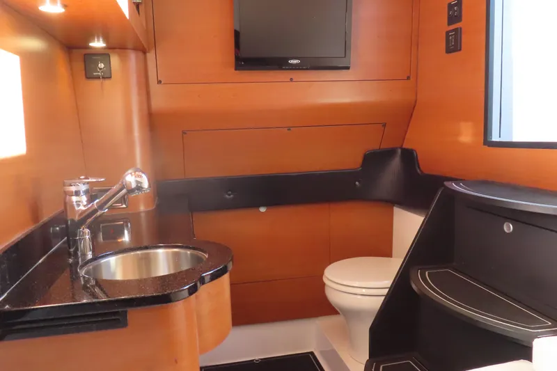 Slide: The Image of Luxurious 2017 Mystic M4200 yacht bathroom with modern fixtures and wood paneling. - 26