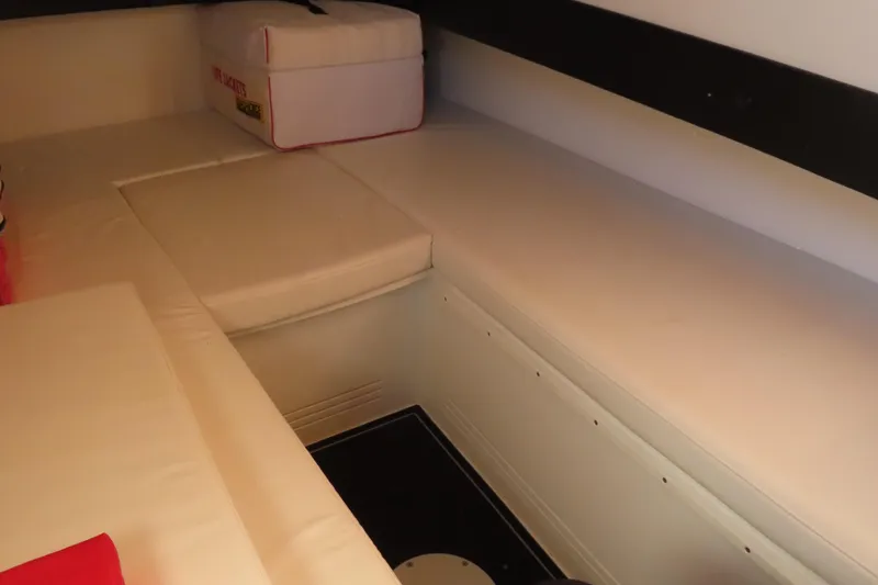 Slide: The Image of Interior cabin of 2017 Mystic M4200 boat with cushioned seating and storage. - 28