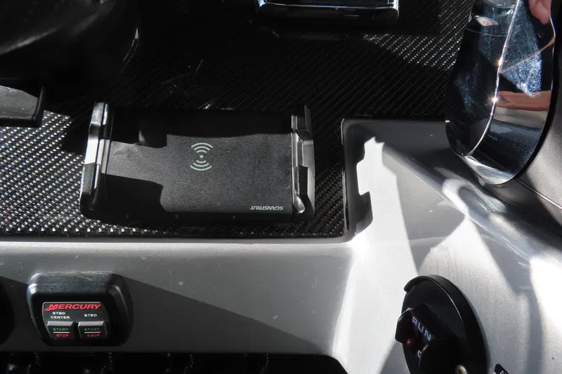 Slide: The Image of Control panel of a 2017 Mystic M4200 boat with wireless charging pad and Mercury controls. - 34