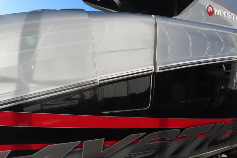 Slide: The Image of 2017 Mystic M4200 boat with sleek design and bold red accents. - 7