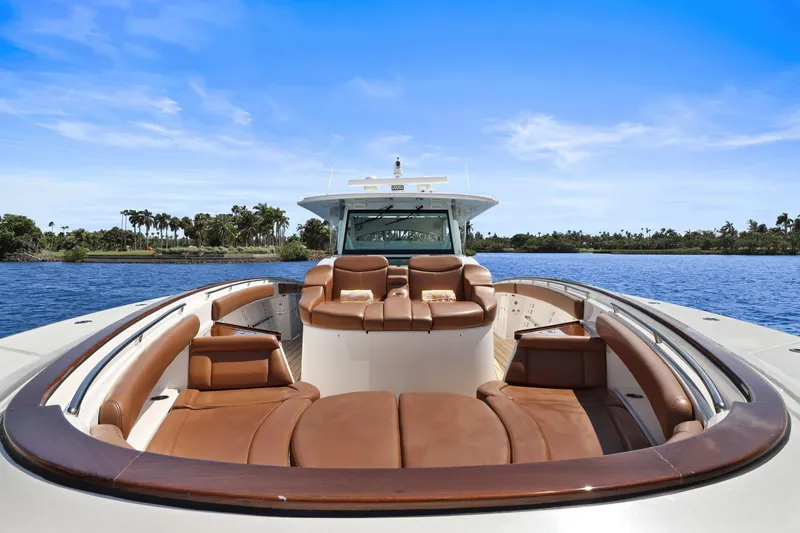 Slide: The Image of 2023 HCB 65 Estrella luxury yacht with brown leather seating on a sunny day. - 24