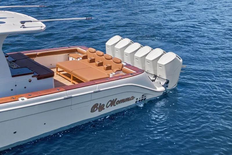 Slide: The Image of 2023 HCB 65 Estrella luxury boat with multiple engines on blue water. - 3