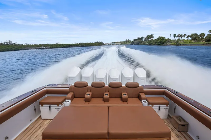 Slide: The Image of Luxury HCB 65 Estrella boat cruising on water, showcasing spacious seating, 2023 model. - 7