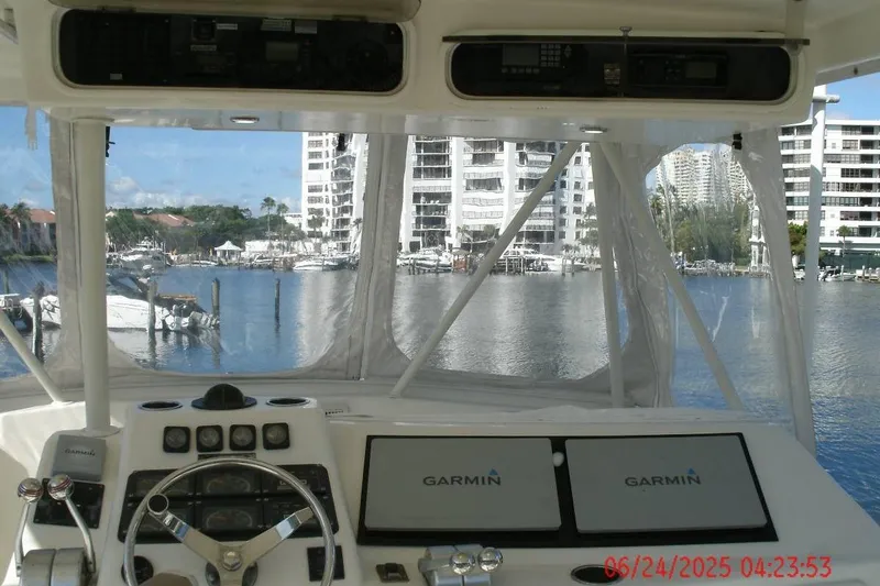 Slide: The Image of Cockpit view of 1998 Ocean Yachts 48 Super Sport with Garmin navigation, overlooking marina. - 10