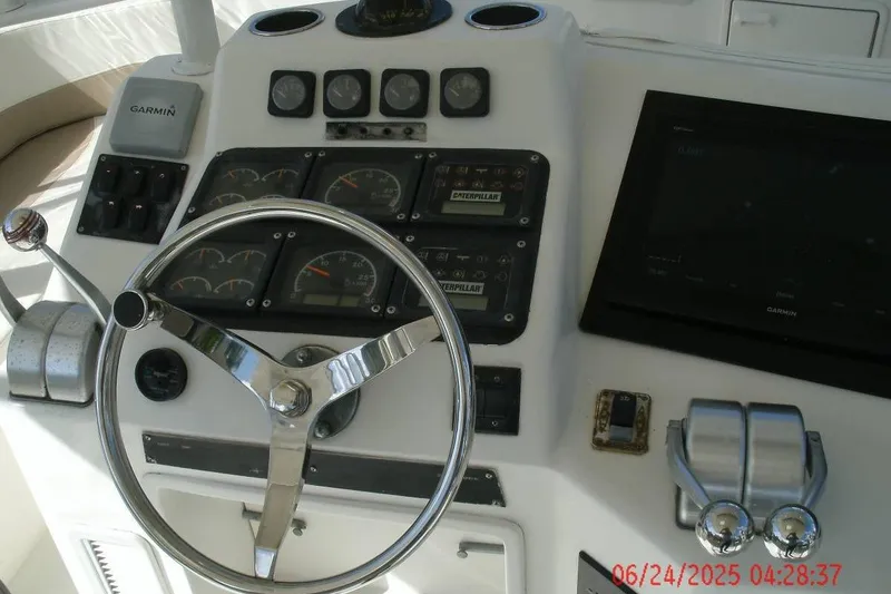 Slide: The Image of Control panel of a 1998 Ocean Yachts 48 Super Sport with steering wheel and gauges. - 12