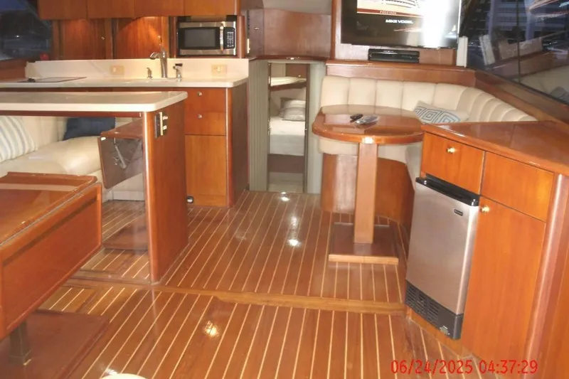 Slide: The Image of Luxurious interior of 1998 Ocean Yachts 48 Super Sport with wood finish and modern amenities. - 15