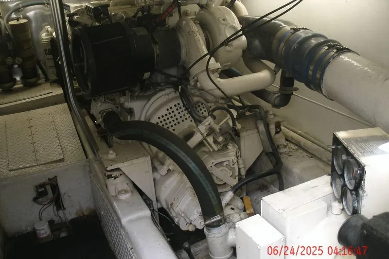 Slide: The Image of Engine room of a 1998 Ocean Yachts 48 Super Sport, showcasing mechanical components. - 5