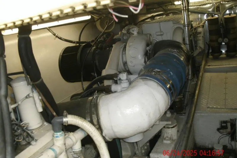 Slide: The Image of Engine room of a 1998 Ocean Yachts 48 Super Sport, showcasing mechanical components and piping. - 6
