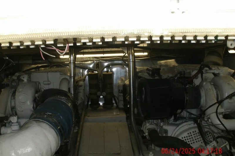 Slide: The Image of Engine room of 1998 Ocean Yachts 48 Super Sport, showcasing dual engines and mechanical components. - 7