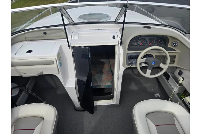 Slide: The Image of 1994 Four Winns 235 Sundowner boat interior with steering wheel and dashboard. - 11