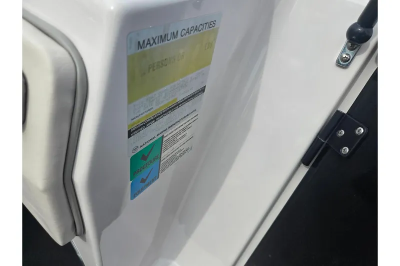 Slide: The Image of 1994 Four Winns 235 Sundowner boat capacity label, showing maximum persons and weight limits. - 12