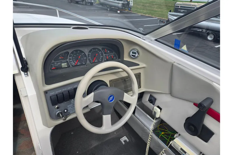 Slide: The Image of 1994 Four Winns 235 Sundowner boat dashboard with steering wheel and instrument panel. - 13