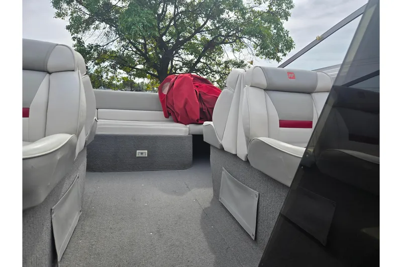 Slide: The Image of Interior of 1994 Four Winns 235 Sundowner boat with gray seating and red cover. - 16