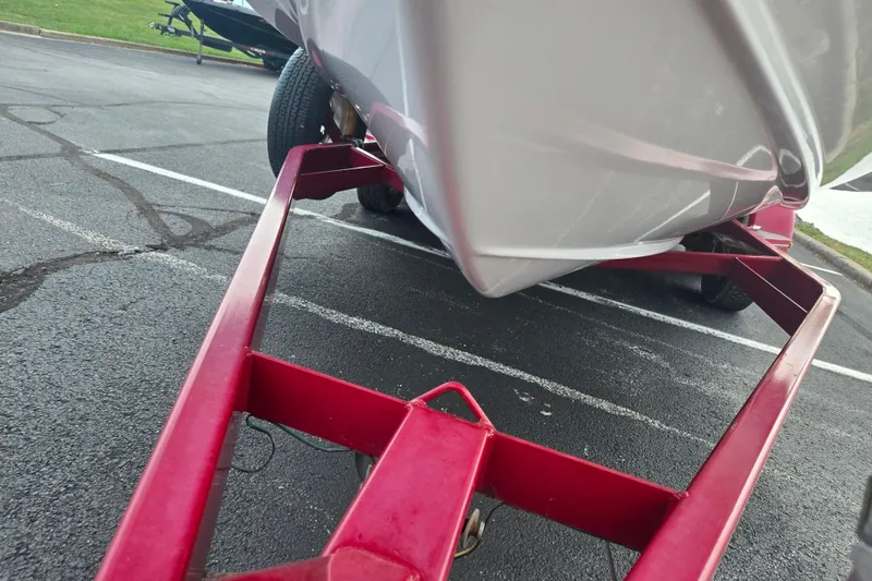 Slide: The Image of 1994 Four Winns 235 Sundowner boat on red trailer in parking lot. - 7