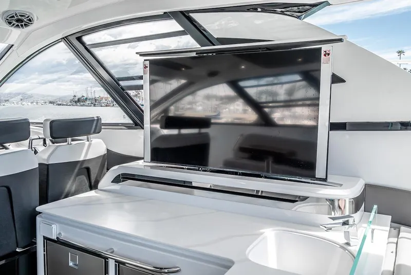 Slide: The Image of 2024 Cruisers Yachts 50 GLS interior with TV and kitchenette. - 42